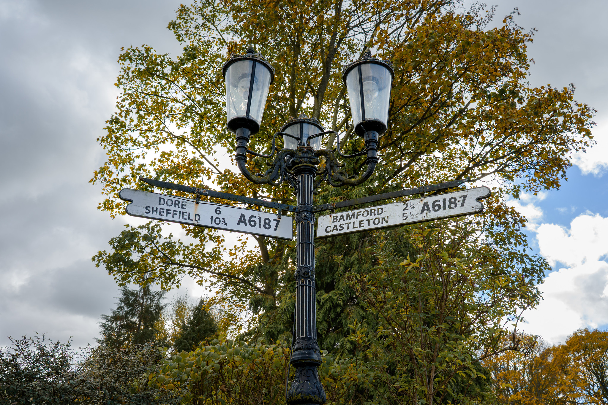 Old road sign in Hathersage village center Peak District Derbyshire UK